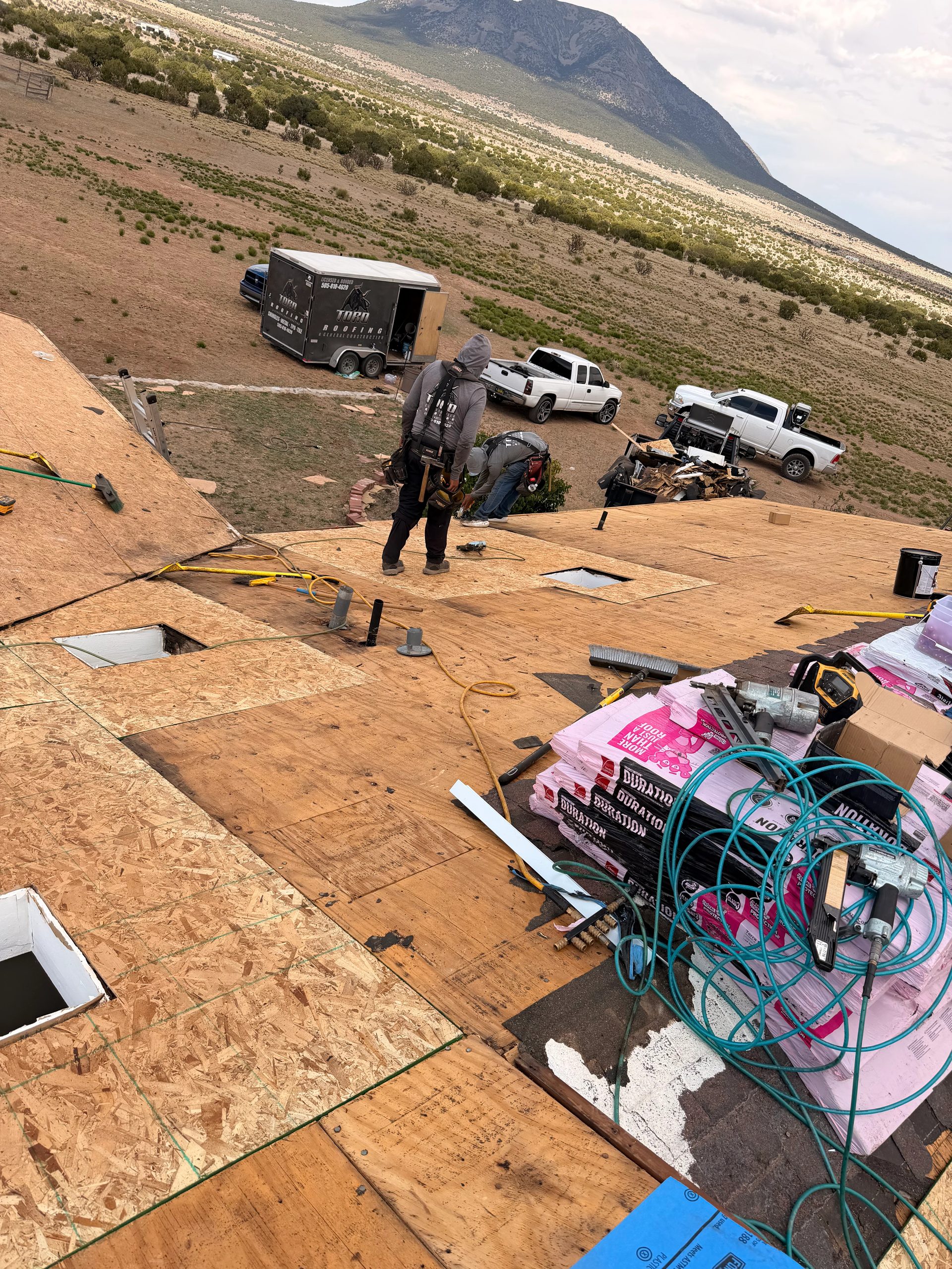 Toro Construction crew installing fresh roof decking on a New Mexico job site