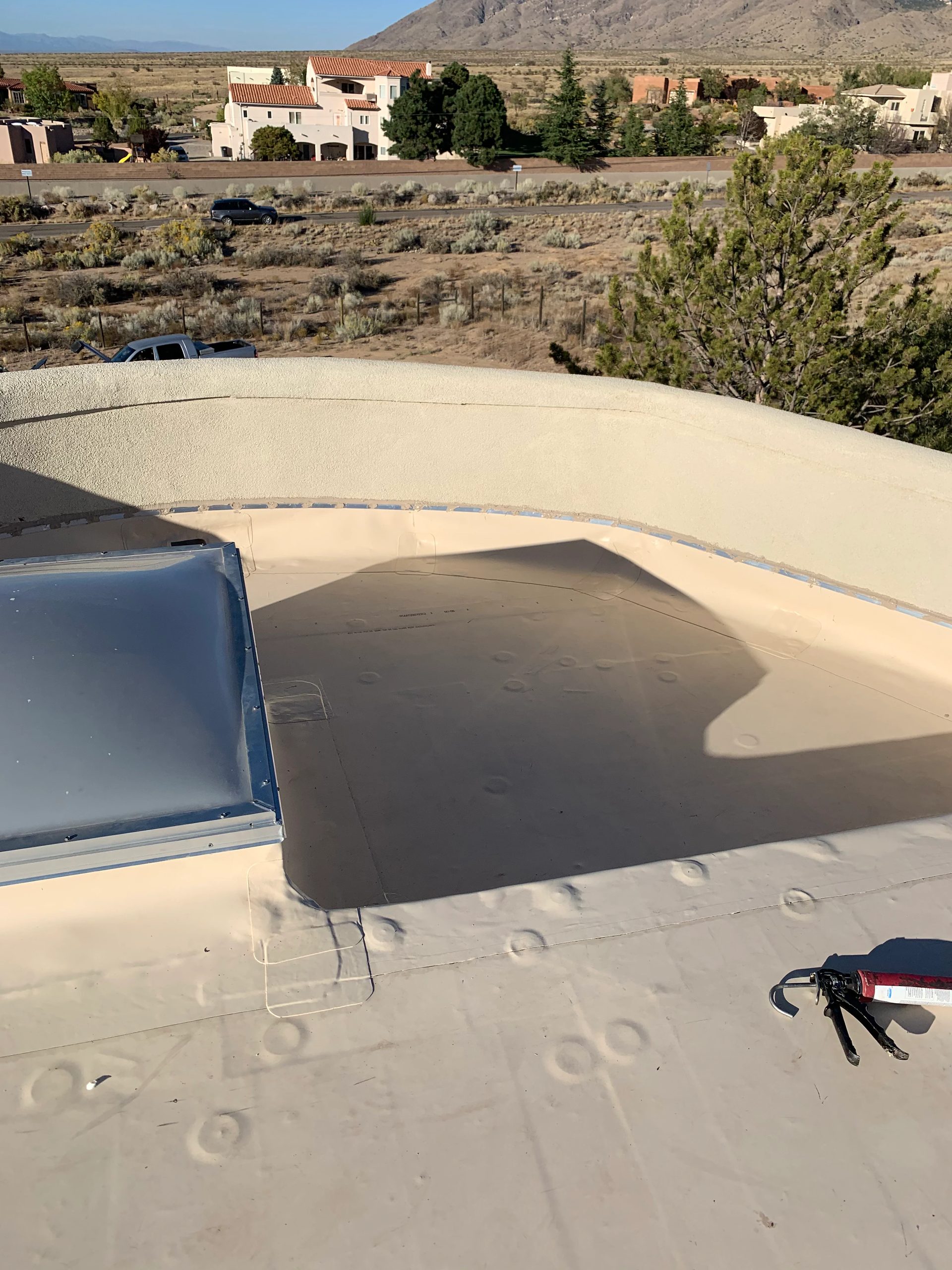 Flat foam roof with a skylight and a mountain peak behind