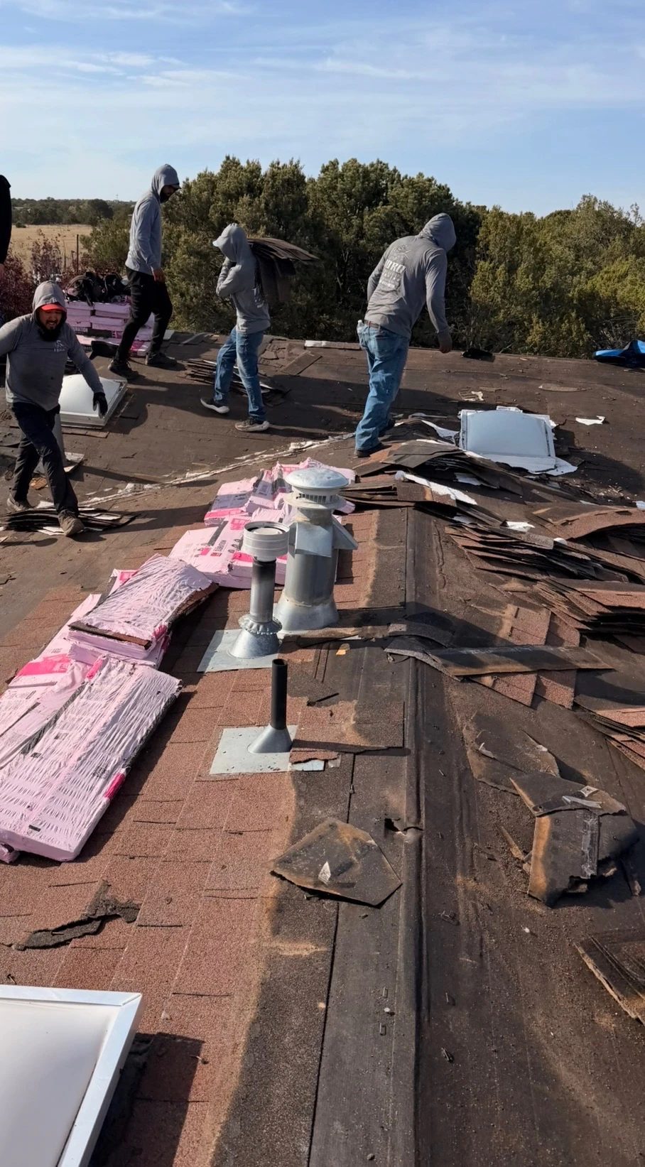 Toro Construction crew tearing off an old roof