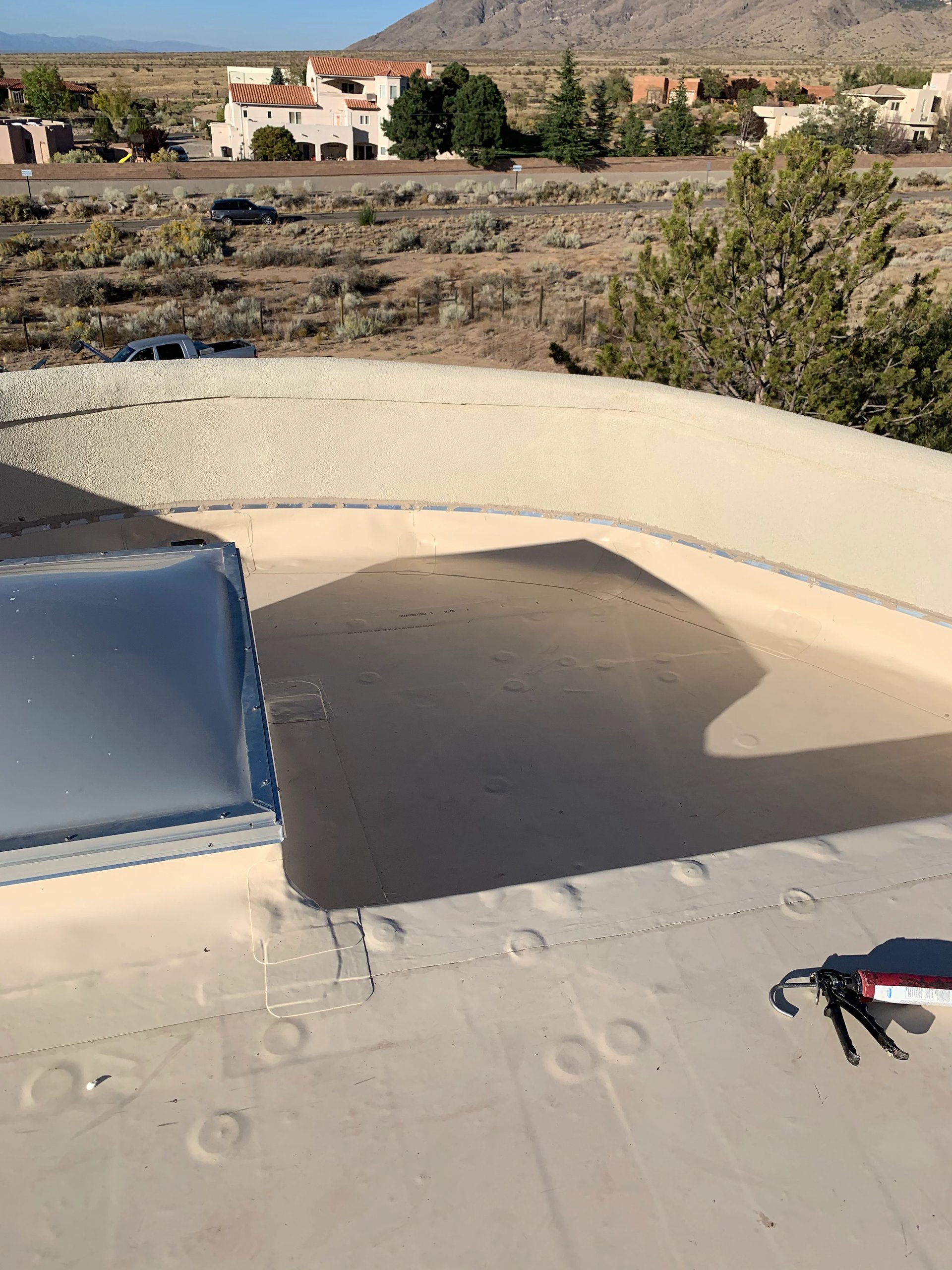 Flat foam roof with a skylight and mountain views
