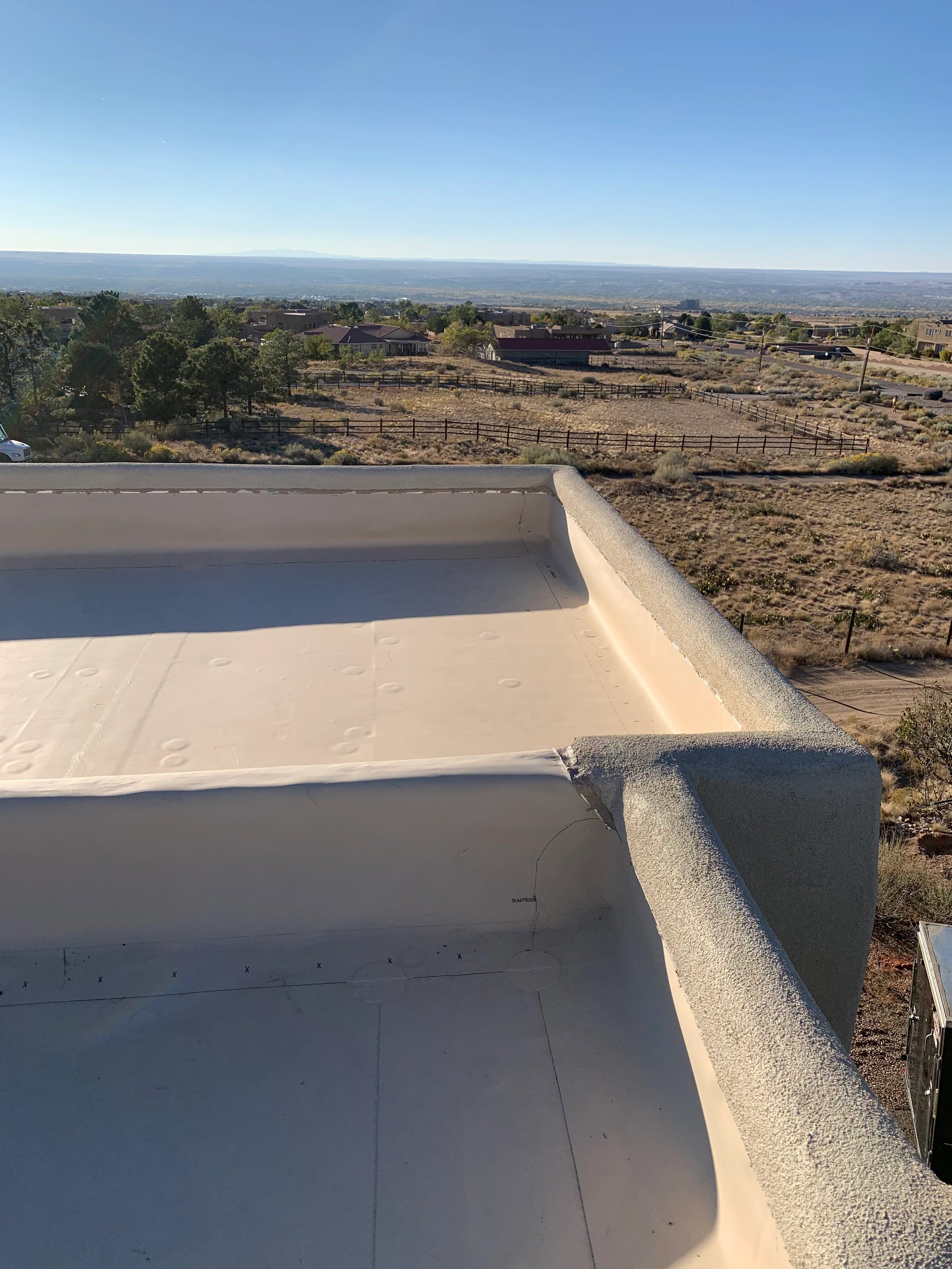 Flat white TPO roof with parapet walls